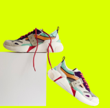 Par de zapatillas unisex con color predominante blanco y trazos en colores naranja, azul, verde y cordones rojos, sobre fondo verde limón